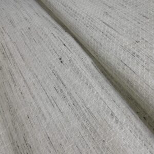 A rustic and elegant slub cotton fabric in a natural off-white shade with organic black streak patterns. Its texture mimics the appeal of raw silk while remaining lightweight and breathable, perfect for ethnic outfits, kurtas, or stylish shirts.